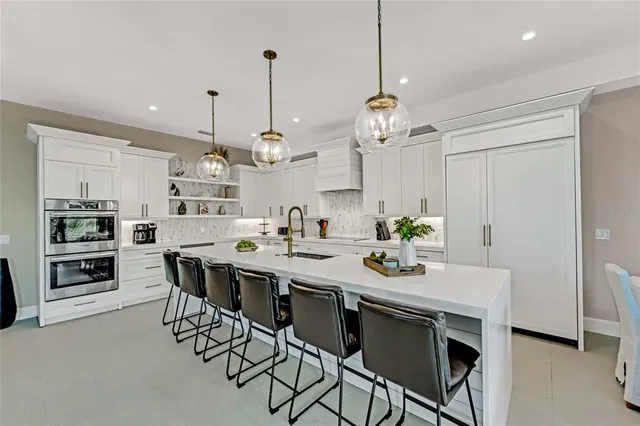 a dining room with stainless steel appliances a table and chairs