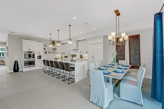 a dining room with furniture and view of kitchen