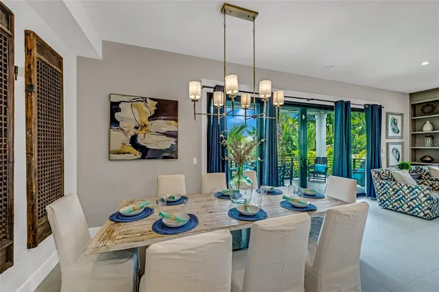 a dining room with furniture large windows and wooden floor