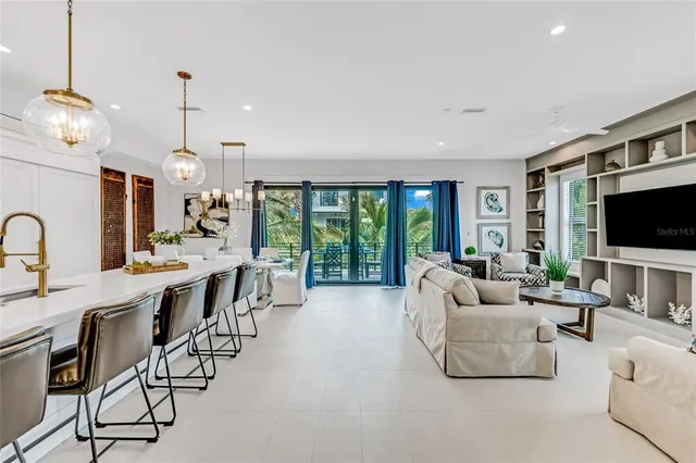 a living room with furniture a flat screen tv and a large window