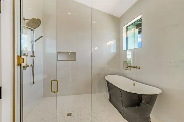 a bathroom with a granite countertop sink a toilet and shower
