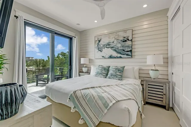 a bedroom with a large bed and a painting on the wall