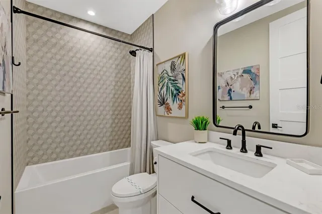 a bathroom with a sink a toilet and a bathtub