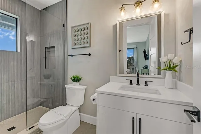 a bathroom with a toilet sink and shower