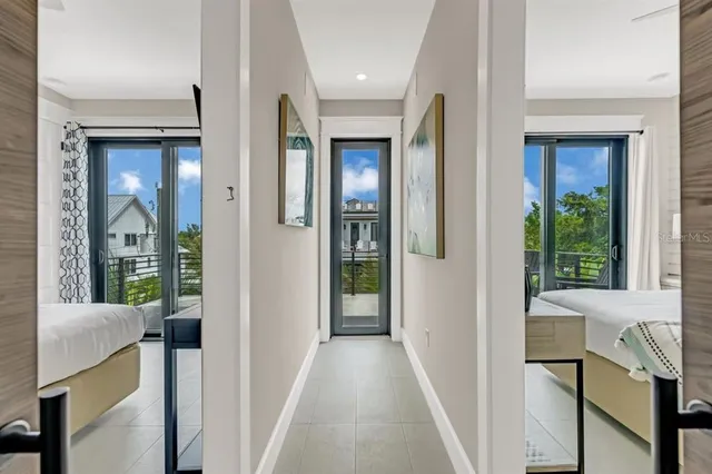 a view of a hallway with a livingroom and furniture