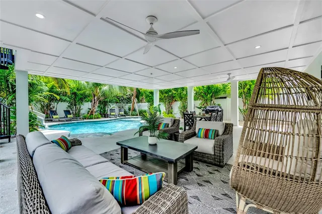 a view of an outdoor dining space with furniture and garden view