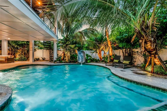 a view of a backyard with porch and garden