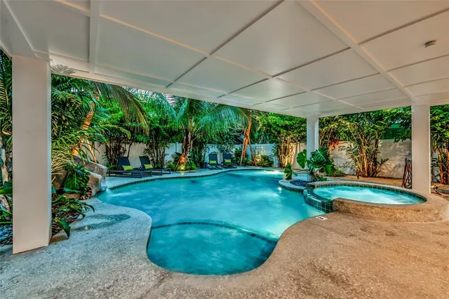 a view of a house with a yard and sitting area