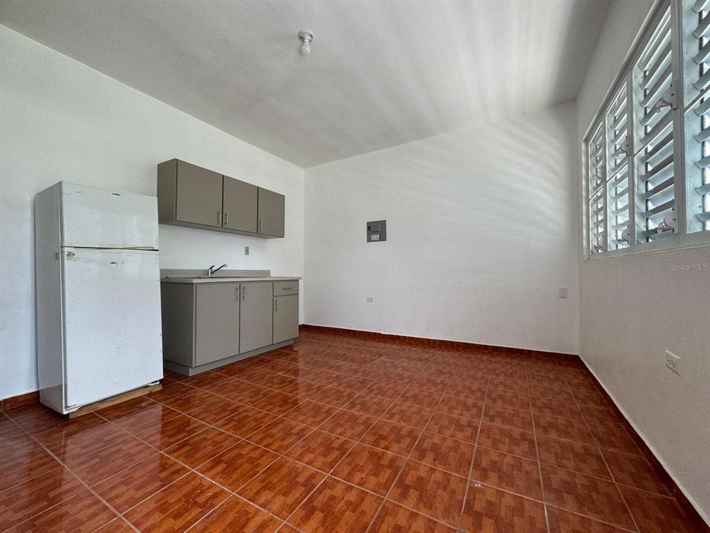 908 Bo Tejas, Unit 7 Humacao, PR 00791 - Photo 4 of 7 a view of kitchen with stainless steel appliances granite countertop a refrigerator and a stove top oven