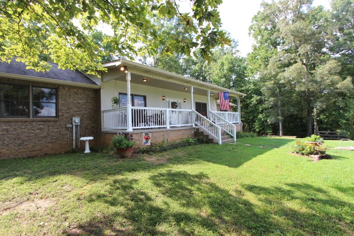 3157 Buckeye Road Erin, TN 37061 - Photo 2 of 41 a view of a house with a yard deck and a large tree