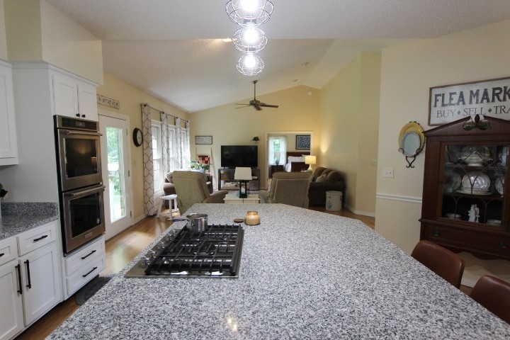 3157 Buckeye Road Erin, TN 37061 - Photo 8 of 41 a living room with furniture a flat screen tv and a fireplace