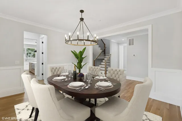 a view of a dining room with furniture and chandelier