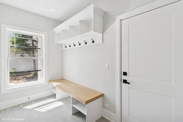 a room with a window and a white cabinet