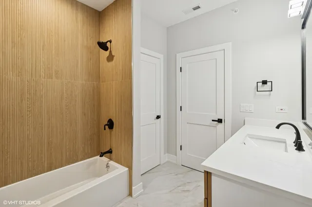 a bathroom with a sink a mirror and a bathtub