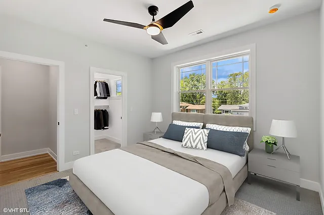 a bedroom with a large bed and a window