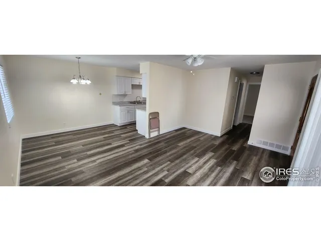 a view of a living room with a sink and cabinets