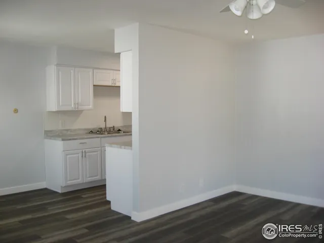 a room with a sink cabinets and wooden floor