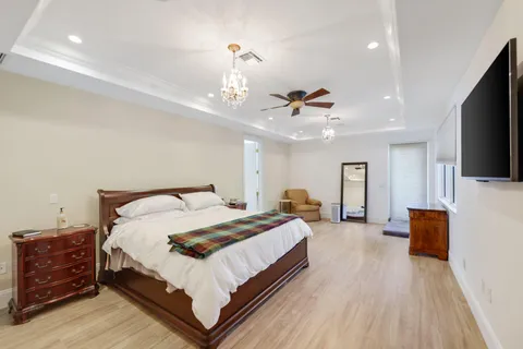 a bedroom with a bed and flat screen tv