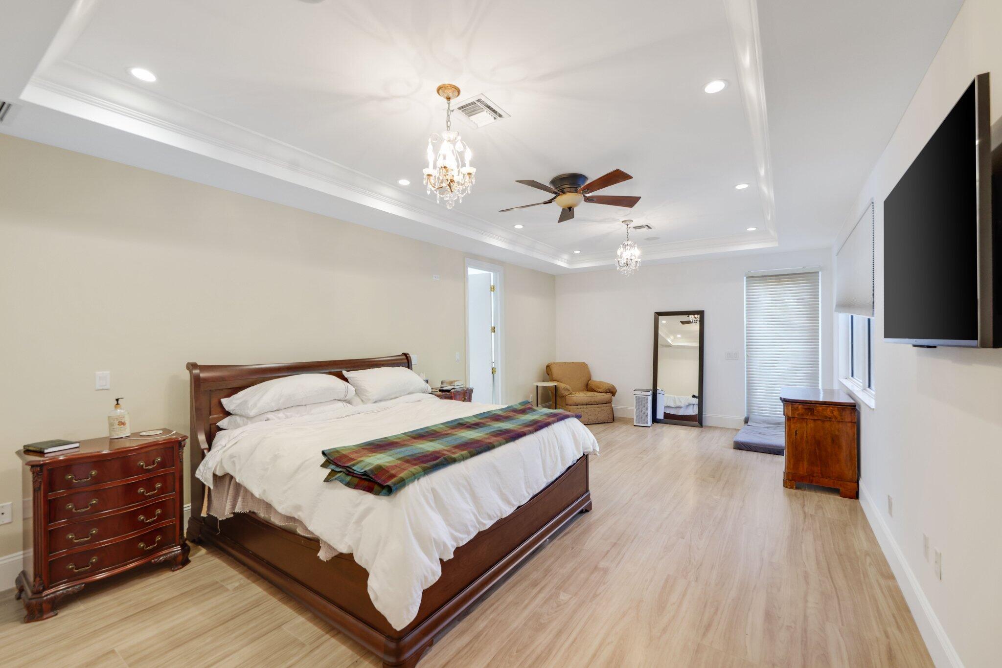 7355 Mandarin Drive Boca Raton, FL 33433 - Photo 11 of 18 a bedroom with a bed and flat screen tv