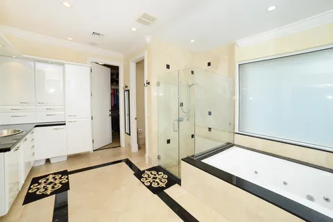 a spacious bathroom with a double vanity sink a large mirror and shower