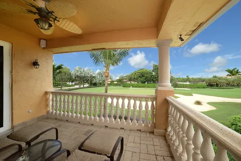 a view of a chair and tables in the balcony