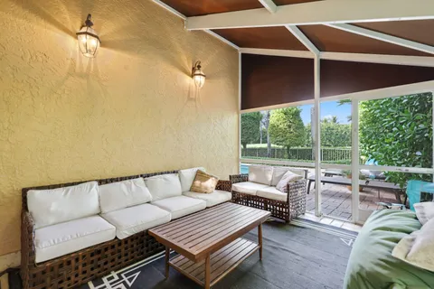 a balcony with furniture and a ceiling fan