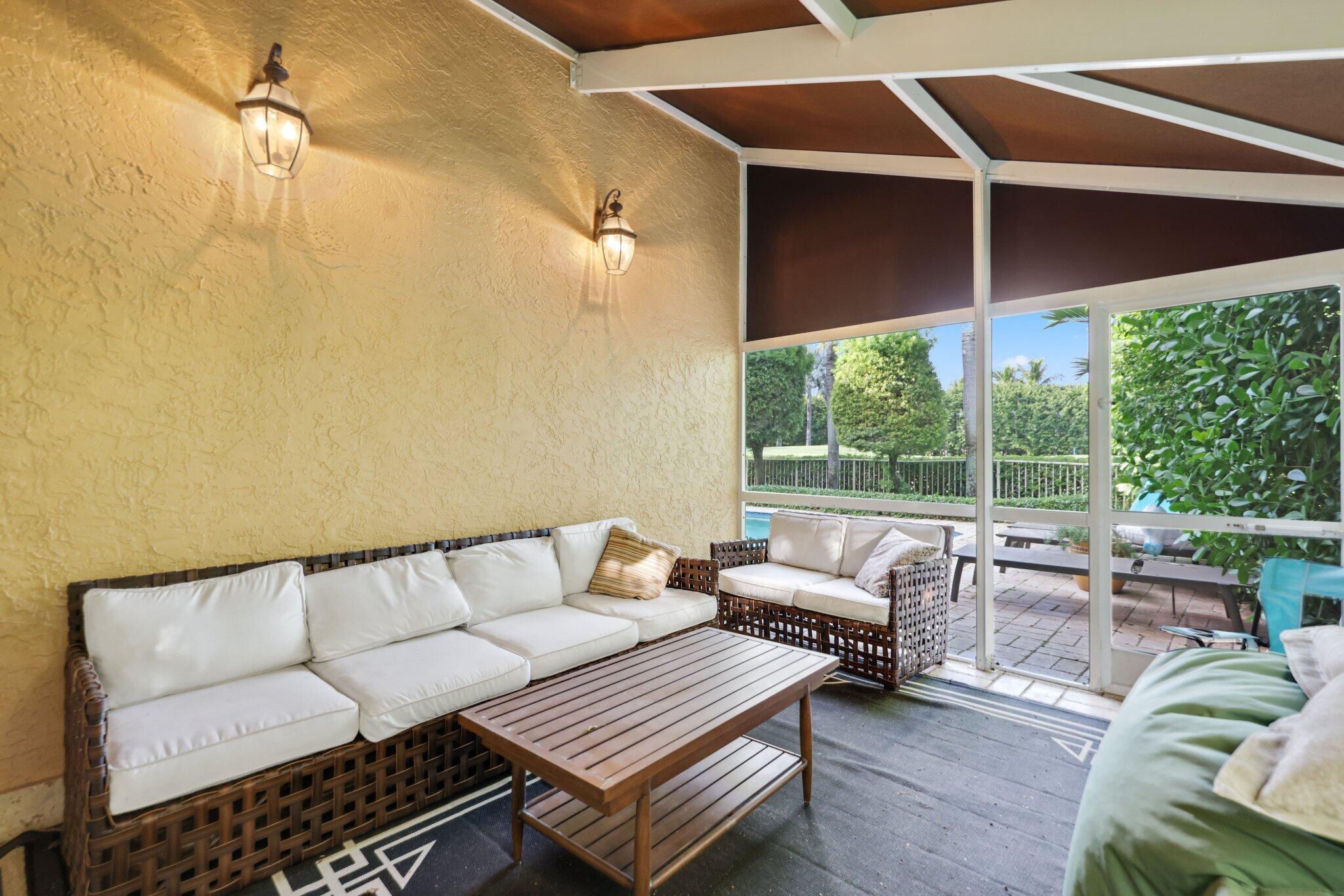 7355 Mandarin Drive Boca Raton, FL 33433 - Photo 16 of 18 a balcony with furniture and a ceiling fan