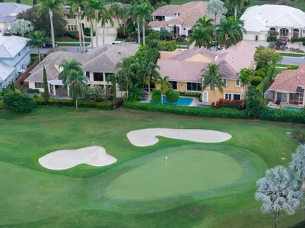 an aerial view of residential houses with outdoor space and street view