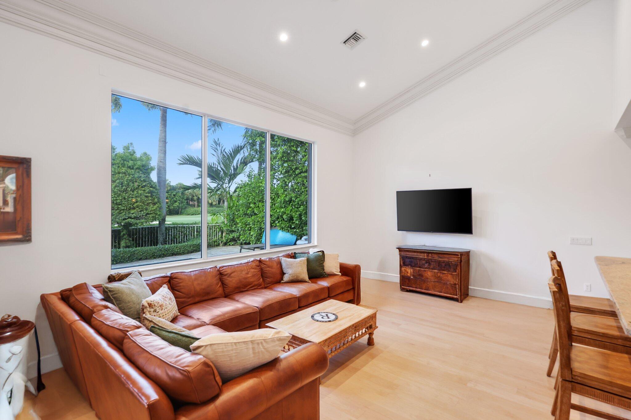 7355 Mandarin Drive Boca Raton, FL 33433 - Photo 6 of 18 a living room with furniture a flat screen tv and a flat screen tv