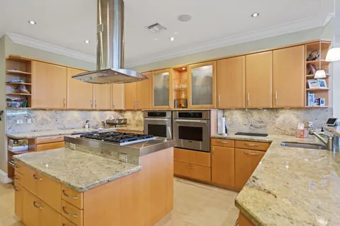 a kitchen with stainless steel appliances granite countertop a stove a sink and a microwave