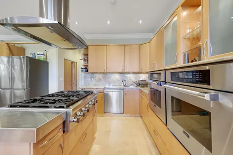 a kitchen with stainless steel appliances granite countertop a stove and a refrigerator
