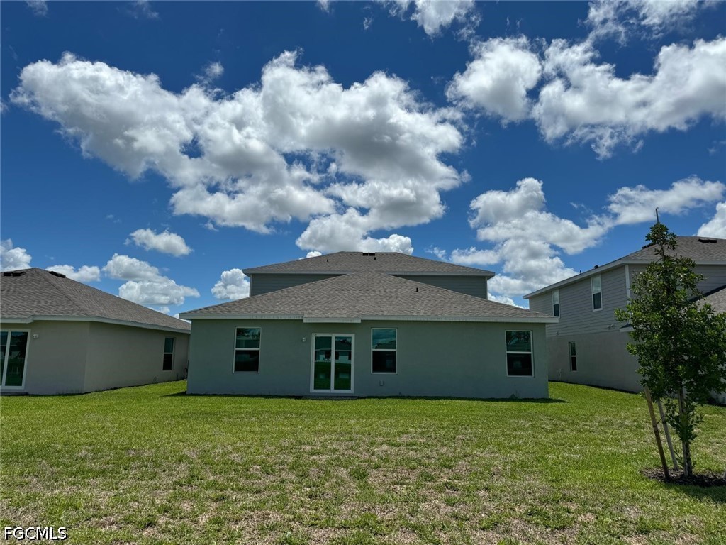 12312 Amber Waves Road Lehigh Acres, FL 33974 - Photo 3 of 33 a view of a house with a garden