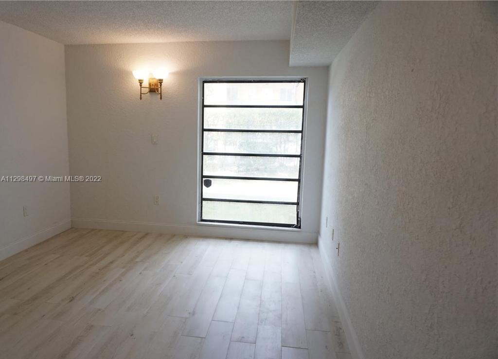 The Crossings Miami, FL 33186 - Photo 12 of 16 an empty room with wooden floor and windows