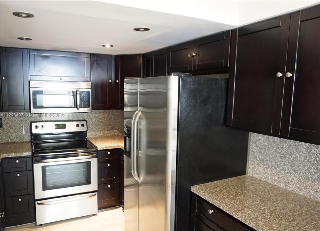 The Crossings Miami, FL 33186 - Photo 13 of 16 a kitchen with a refrigerator and a stove