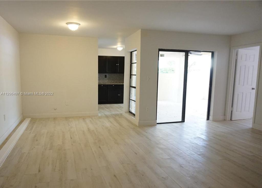 The Crossings Miami, FL 33186 - Photo 15 of 16 an empty room with wooden floor and windows