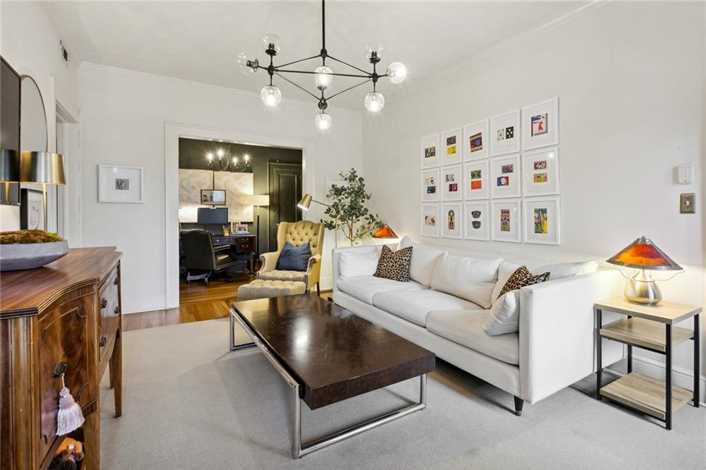 a living room with furniture and a chandelier