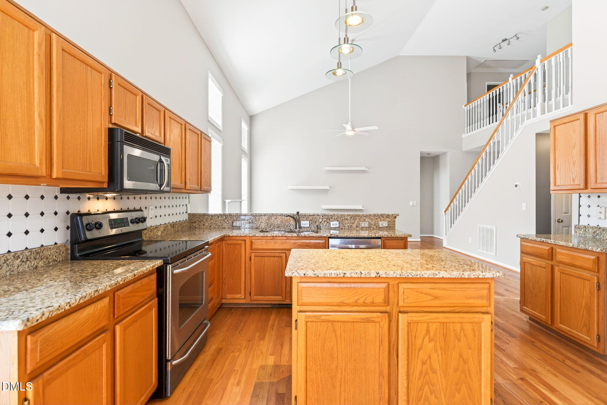 303 Roebling Lane Cary, NC 27513 - Photo 12 of 30 a kitchen with stainless steel appliances granite countertop a sink stove and refrigerator