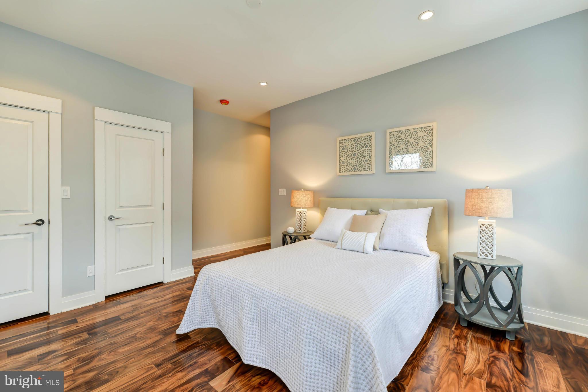 1719 Lincoln Road Northeast, Unit 2 Washington, DC 20002 - Photo 22 of 26 a bedroom with a bed and wooden floor
