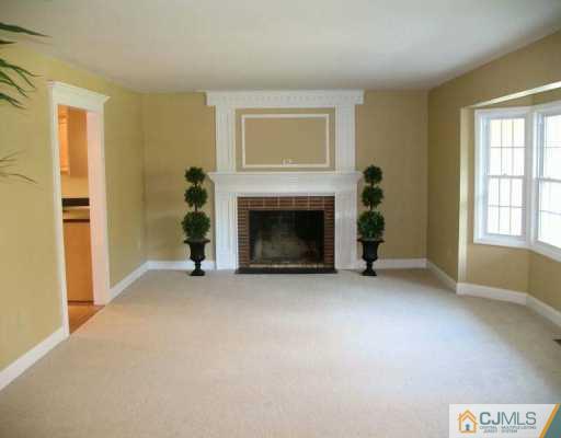 1 Hughes Road Somerset, NJ 08873 - Photo 2 of 8 an empty room with windows and fireplace