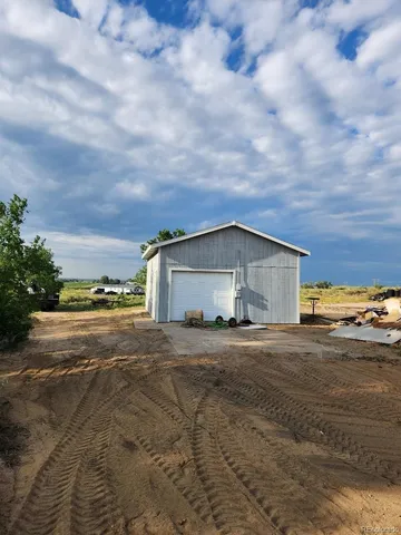 a view of large house with a big yard and a large parking space
