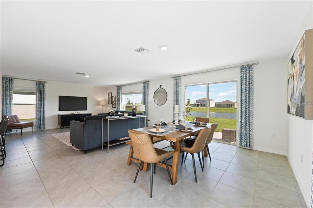16716 Glacier Bay Loop Wimauma, FL 33598 - Photo 3 of 13 a view of a dining room with furniture window and outside view