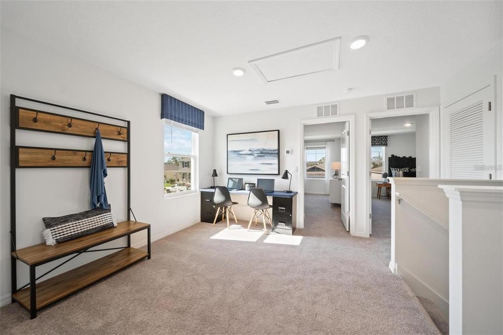 16716 Glacier Bay Loop Wimauma, FL 33598 - Photo 5 of 13 a living room with furniture gym equipment and a large window