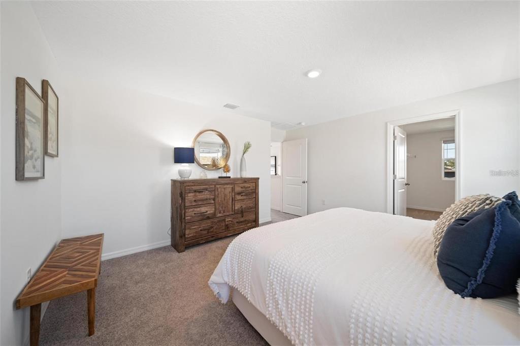 16716 Glacier Bay Loop Wimauma, FL 33598 - Photo 6 of 13 a bedroom with a bed and a couch