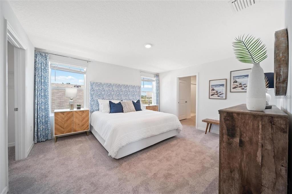 16716 Glacier Bay Loop Wimauma, FL 33598 - Photo 7 of 13 a spacious bedroom with a bed and a couch