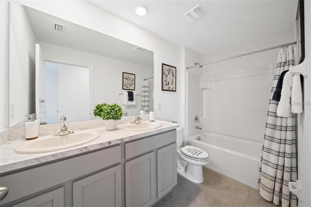 16716 Glacier Bay Loop Wimauma, FL 33598 - Photo 8 of 13 a bathroom with a granite countertop sink toilet and shower