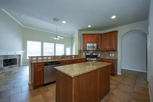 a kitchen with a stove sink and microwave