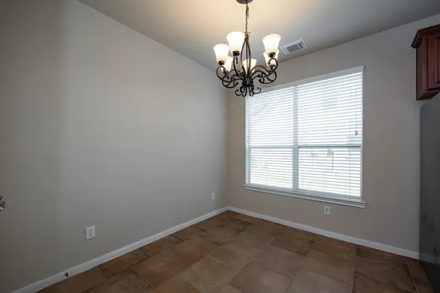 a view of a chandelier in a room with a window