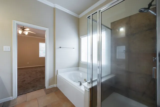 a bathroom with a glass shower door and a mirror