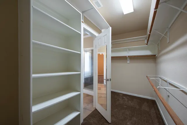 a view of an empty walk in closet
