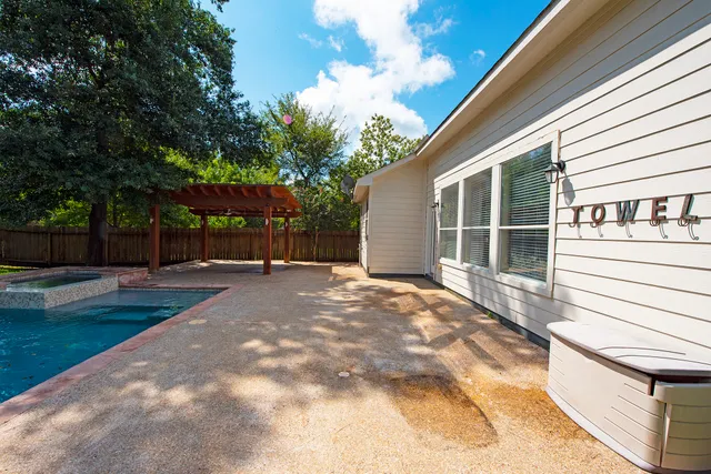 a view of a backyard with sitting area